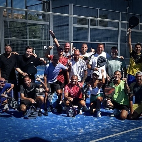 Happy padel players continuing their Bee-Padel.com Intensive Clinics under the sun after a short rain, using the Courtcovers All-Weather Padel Court Cover to protect the court.